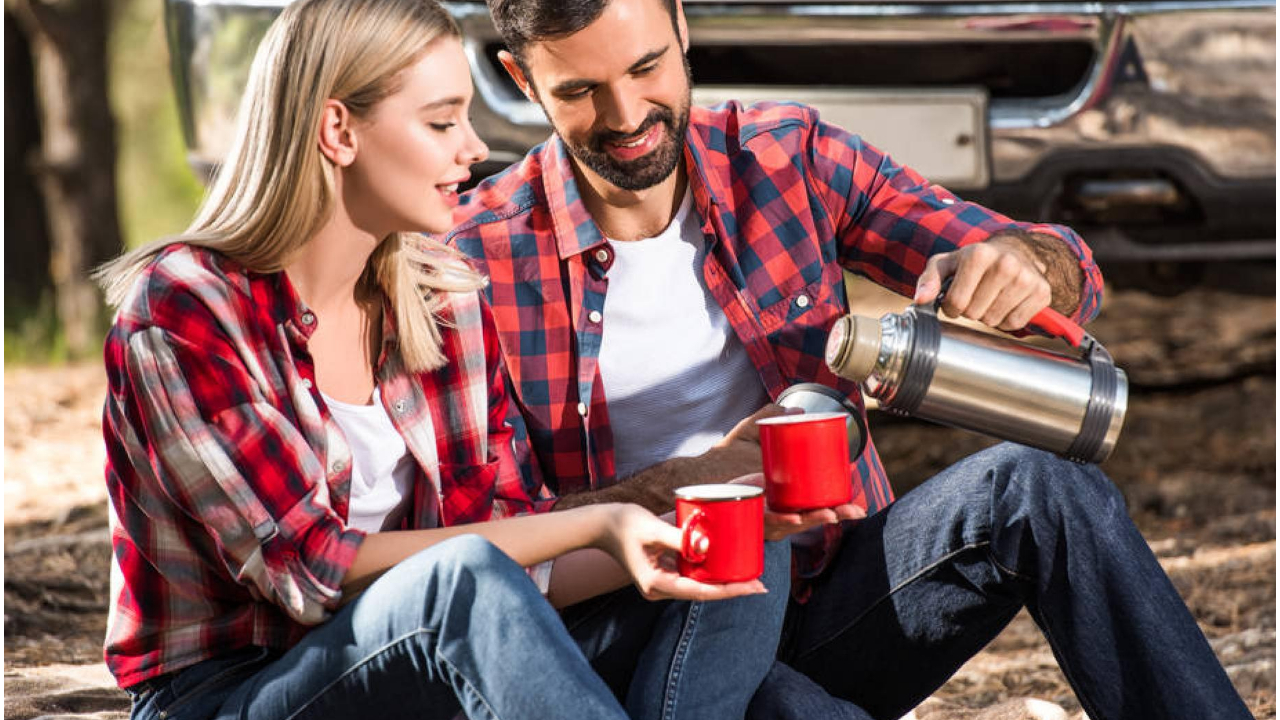 Voluminous marching thermos for hot tea or coffee stands on ground